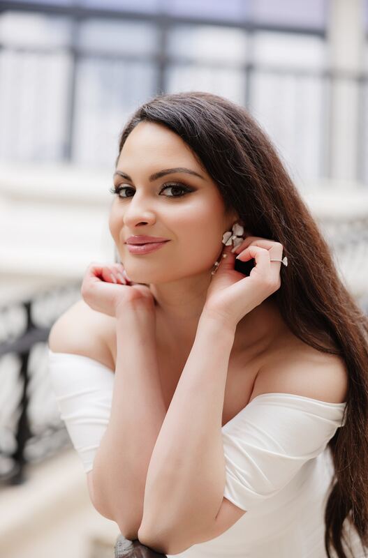 Iviani smiling softly in an off-the-shoulder gown