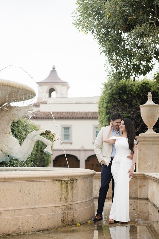 Joey and Iviani at the edge of the stone fountain