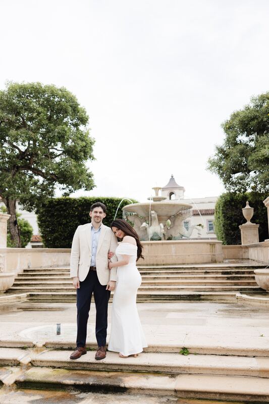 Iviani and Joey embracing on the fountain steps