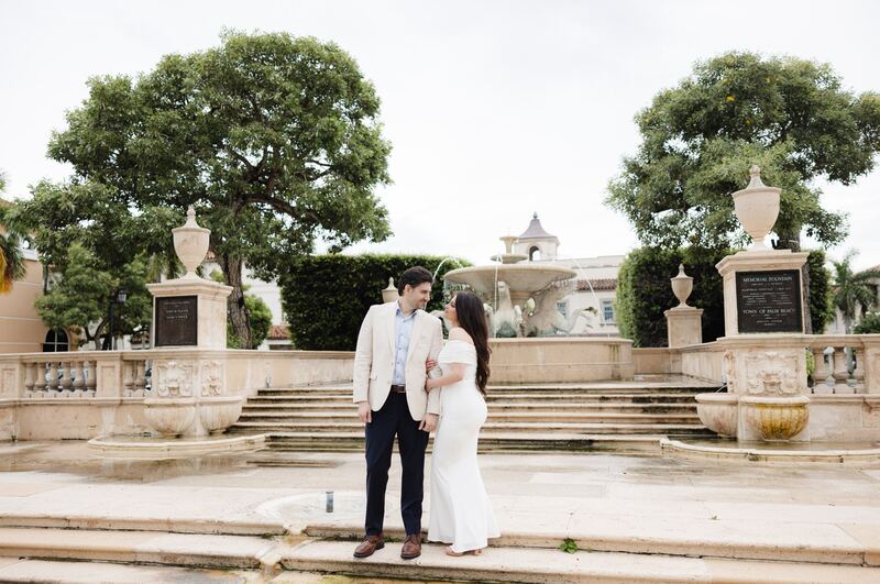 Iviani and Joey kissing on the fountain steps