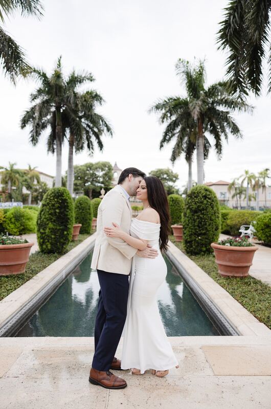 Iviani and Joey embracing at the end of the reflecting pool