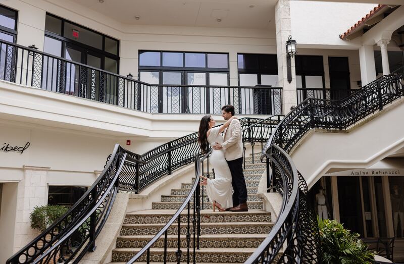 Iviani and Joey on a sweeping wrought-iron staircase