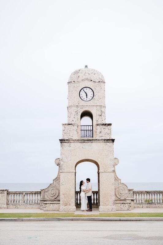 Iviani and Joey beneath the Worth Avenue clock tower, the ocean beyond